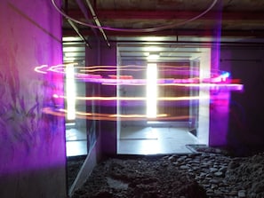Um espaço interior com uma superfície refletora e uma porta que dá para outra área.