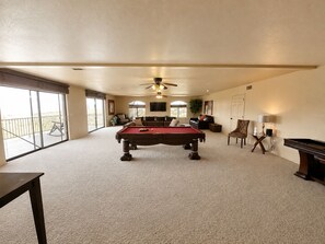 A spacious room with a pool table, a sofa, and a television. - The Prescott Social + Near Whiskey Row + Views (Prescott)