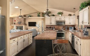 A modern kitchen with a central island, stainless steel appliances, and light wood cabinetry. - The Prescott Social + Near Whiskey Row + Views (Prescott)