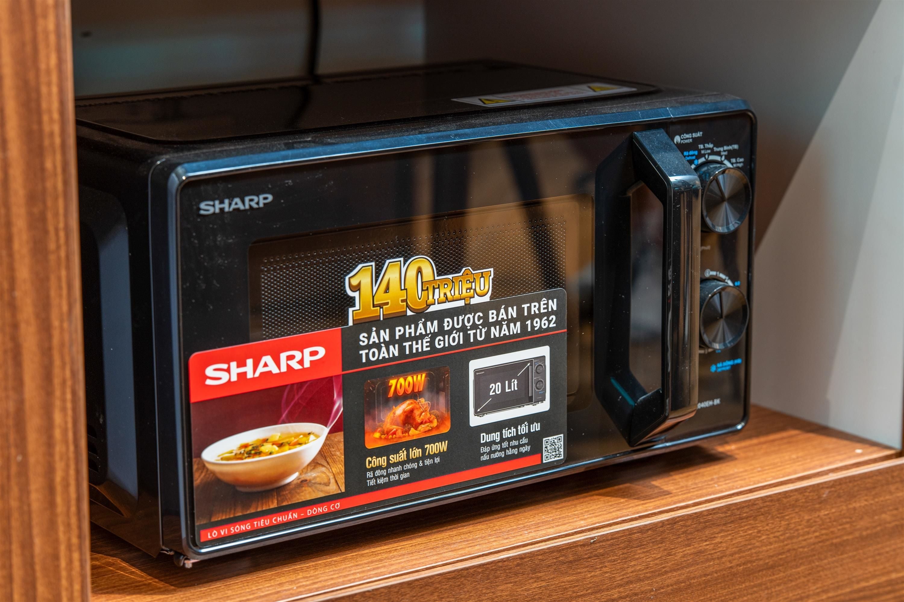 A black Sharp microwave oven with a digital display and a red Sharp logo.