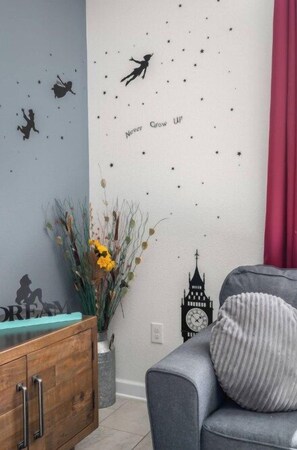 A room with a wall decorated with stars and silhouettes, a clock, and a motivational quote. - 4BR Disney Getaway | Pool, Pirate & Castle Rooms (Davenport)