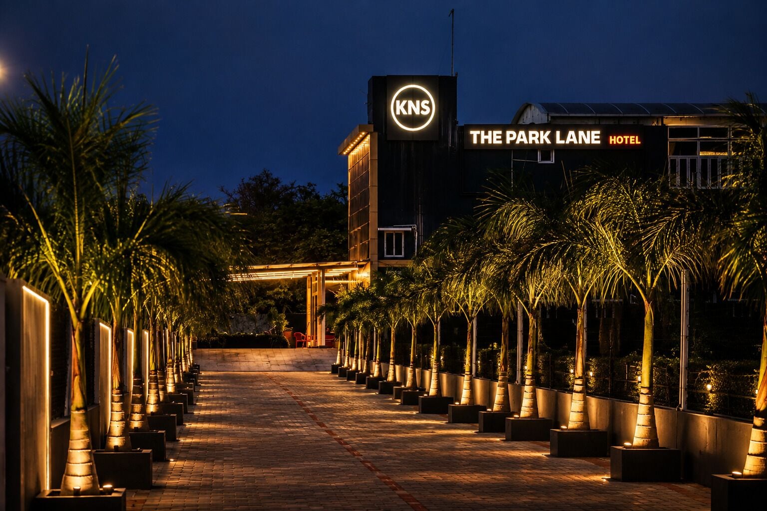 A hotel entrance with a sign for 'The Park Lane Hotel' and a logo for 'KNS'.