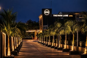 A hotel entrance with a sign for 'The Park Lane Hotel' and a logo for 'KNS'. - The Park Lane Hotel (Krishnagiri)