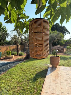 A wicker hanging light fixture in a garden setting. - Terra Olive Hideaway 3 bedroom villa (Pegeia)