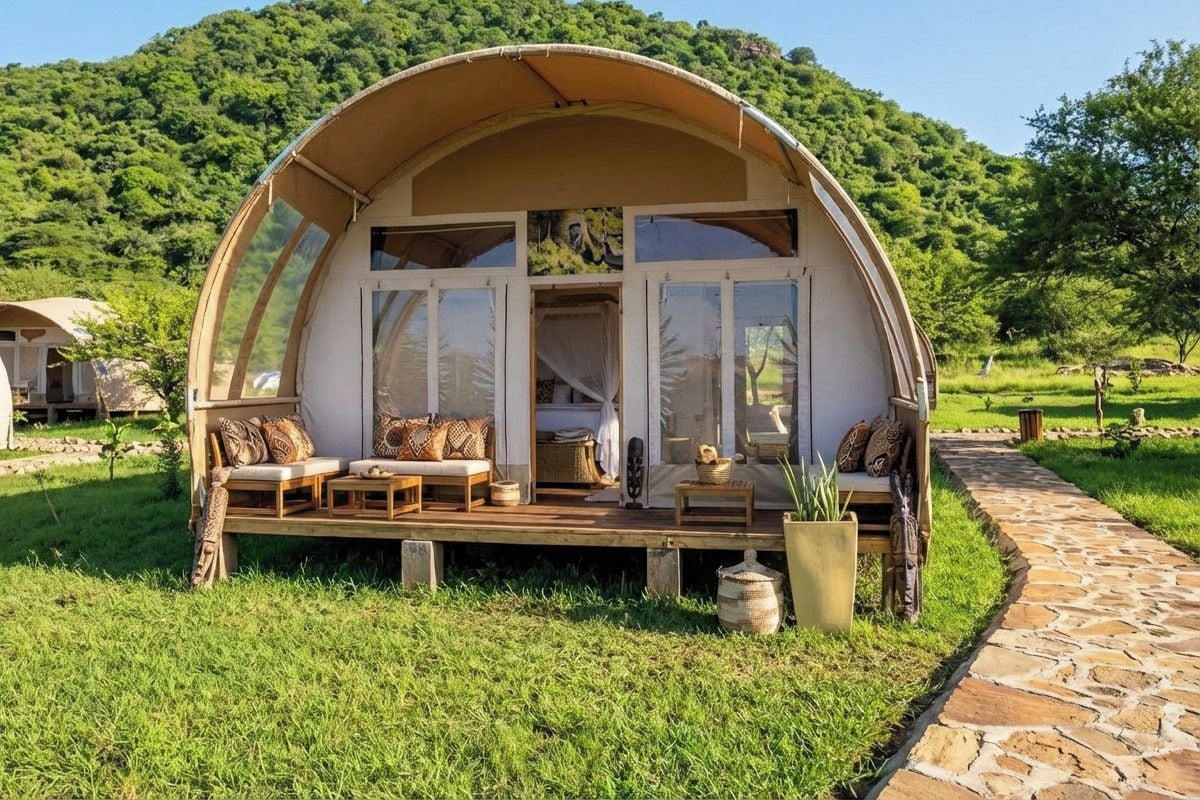 A dome-shaped structure with a porch, seating area, and potted plants.
