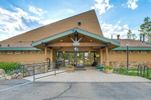 A building with a triangular roof, a covered entrance, and a stone wall. - Dock + Hot Tub! Waterfront Lake Tahoe Getaway (South Lake Tahoe)