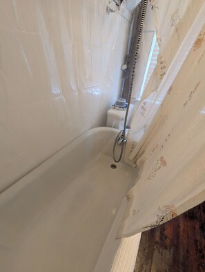 A bathroom with a bathtub, shower, and toilet. - New York City with the Family—Your Home Base on Staten Island—Perfect for 2–4! (Staten Island)