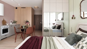 A modern bedroom with a bed, bedside table, and a mirror. There is a separate dining area with a table and chairs. The room has a kitchenette with an oven and a sink. - Studio 54, Holzera, Wilanów, Warsaw (Warszawa)