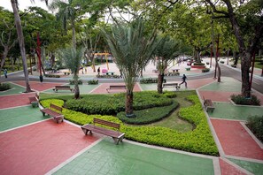 A park with benches, pathways, and trees. - Stylish Downtown KingBed 300mb fast wifi! (Santo Domingo)
