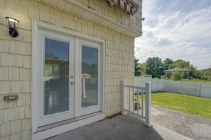 A building with a double door, a small porch, and a white fence.