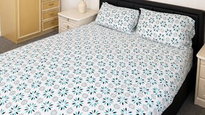A bedroom with a bed, a wardrobe, a nightstand, a vase with flowers, and two wall art pieces. - Private Room in Wolverhampton city perfect for contractors and Fb fans (Wolverhampton)