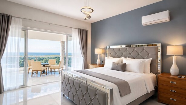 A modern bedroom with a large bed, a balcony with a view, and a ceiling-mounted air conditioning unit. - Villa with pool near Laguna Gri-Grí and beaches (Río San Juan)