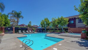 A rectangular swimming pool with a blue border, surrounded by lounge chairs and a paved deck. - SoCal Studio w/ Pool & Hot Tub Access (Rancho Santa Margarita)