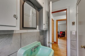 A bathroom with a sink, mirror, and shower. - Quiet Stuart Retreat w/ Yard & Fireplace (Stuart)