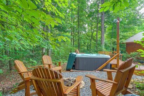 An outdoor seating area with wooden chairs and a hot tub surrounded by trees. - Private Hot Tub & Deck! Cherry Log Gem (Cherry Log)