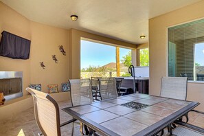 A patio with a table and chairs, a grill, and a view of the landscape. - Las Cruces Oasis: Patio, Hot Tub + Mtn Views (Las Cruces)
