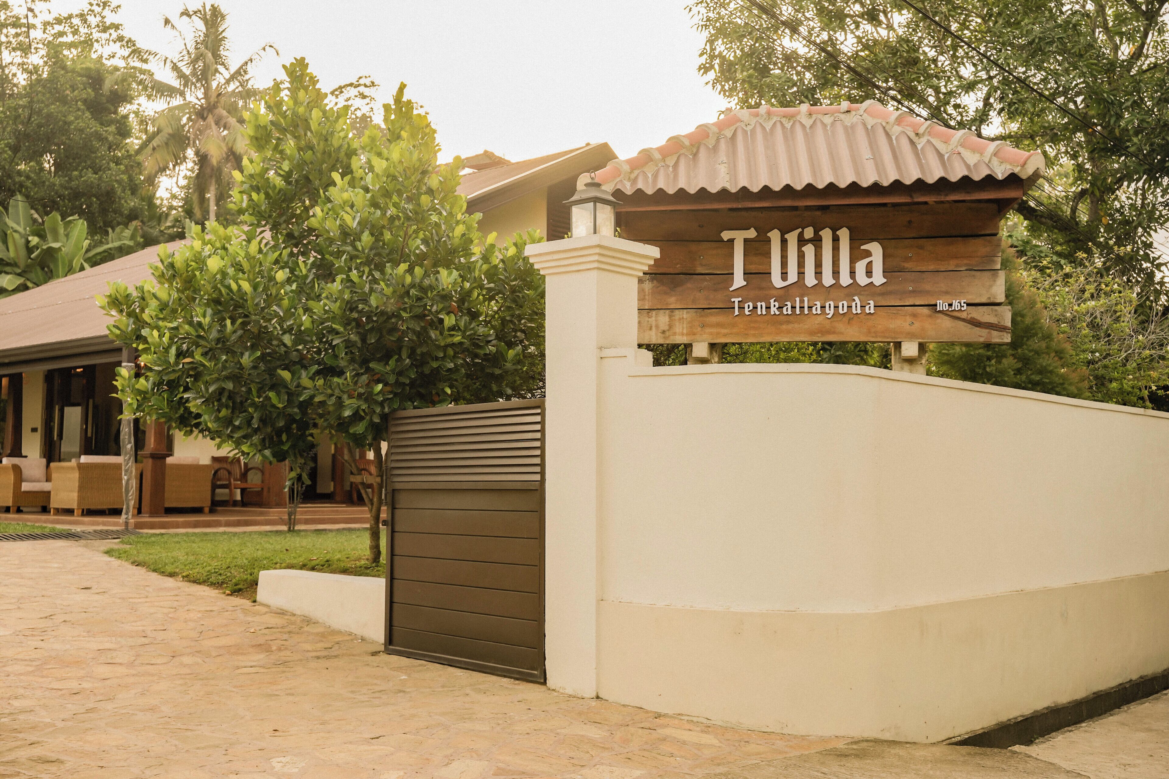 A villa entrance with a sign reading 'Villa Tenkillagoda No. 65'.