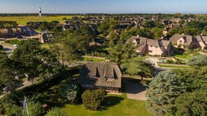 A residential area with houses, a lighthouse, and a flagpole. - Holiday home in Kampen with swimming pool (Kampen)
