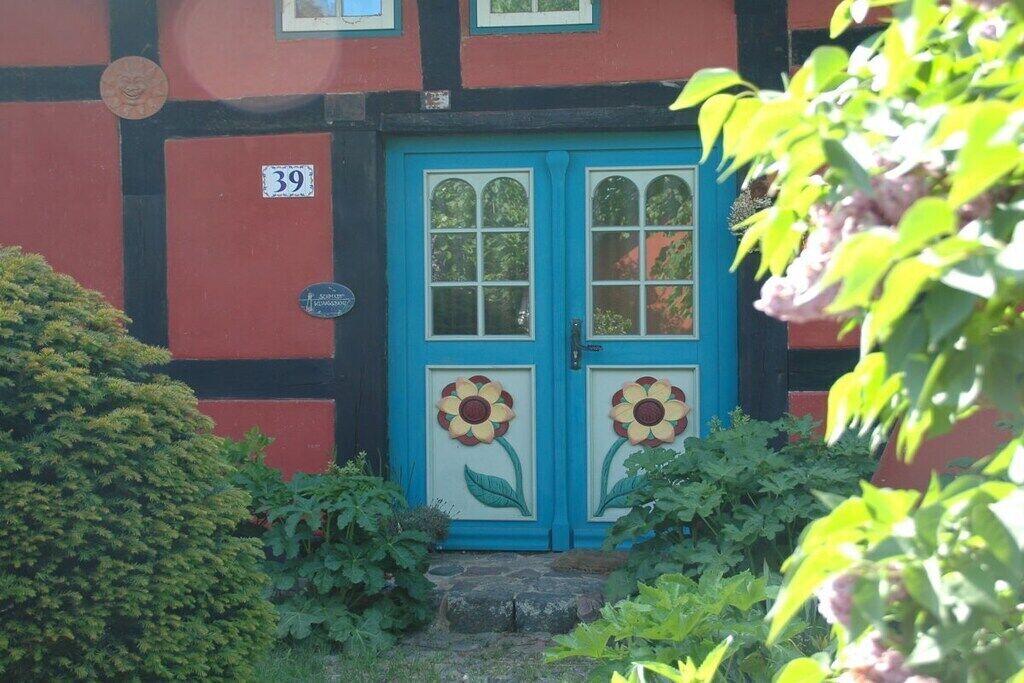 A building with a blue door featuring a flower design, number 39, and a small sign above the door.