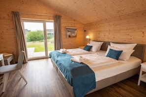 A room with a bed, a desk, and a chair.