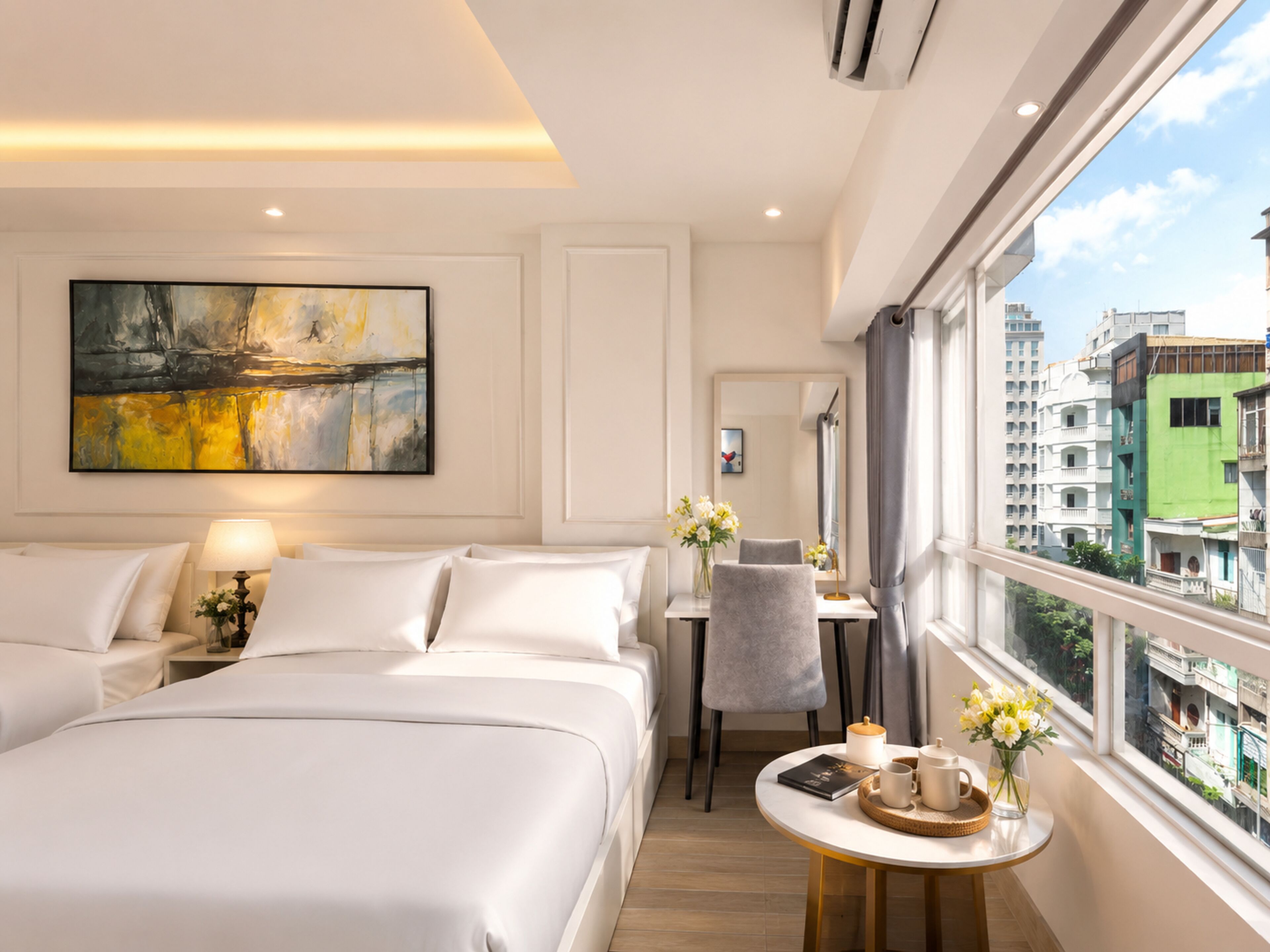 A hotel room with a large bed, a desk, a chair, a window with a city view, and a painting on the wall.