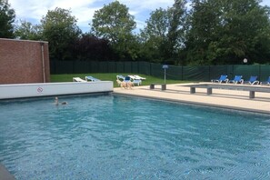 A swimming pool with lounge chairs and a no swimming sign. - Holiday home with 3 bedrooms (BX Herkingen)