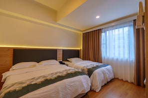 A hotel room with two beds, a wooden headboard, a nightstand, and a window with curtains. - SunnyPlace (ParaƱaque)