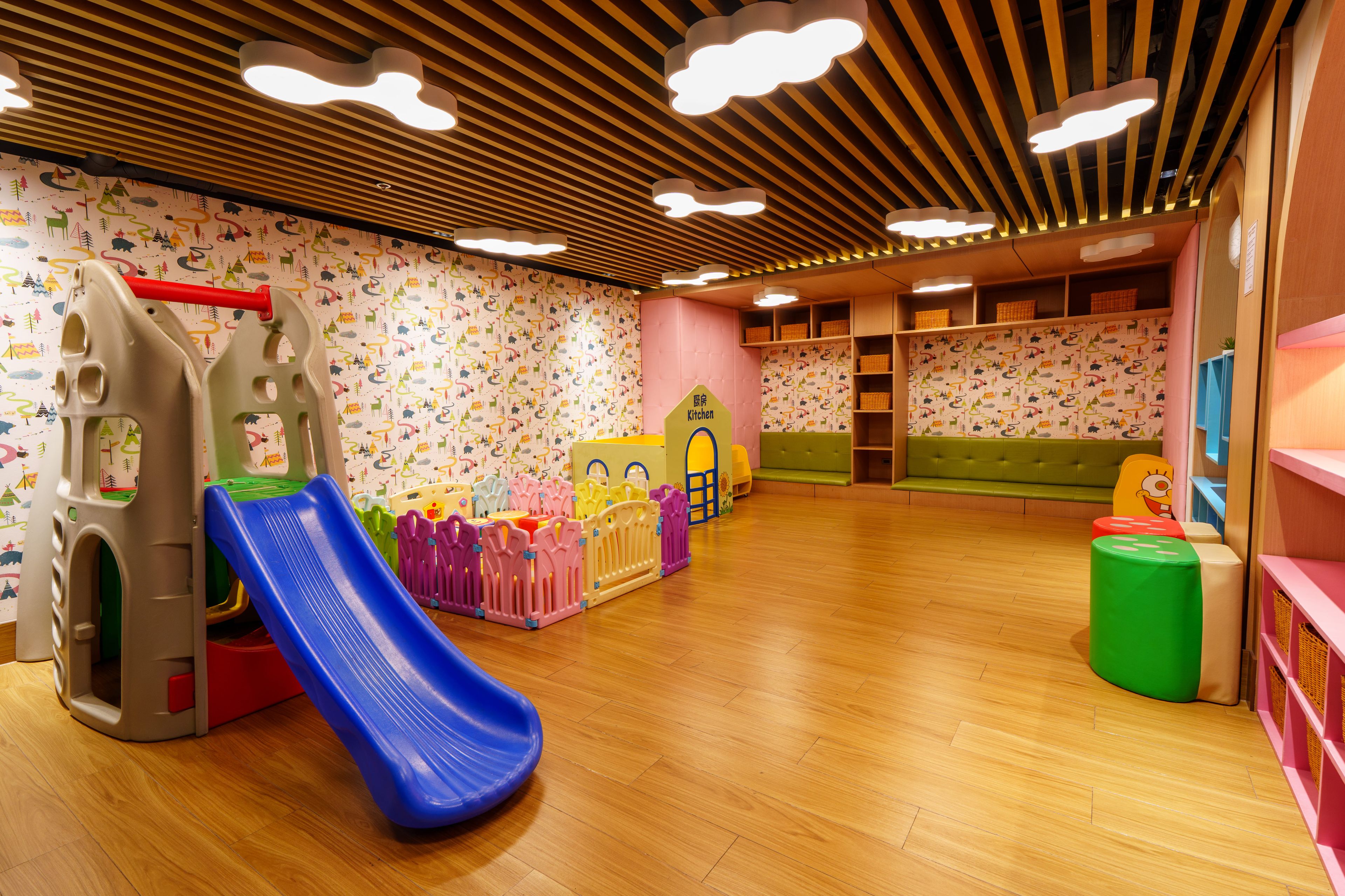 A children's play area with a slide, play structures, and a kitchen play area.