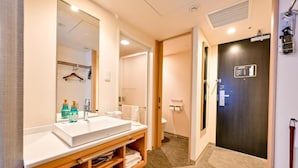 A hotel bathroom with a large mirror, a sink, and a towel rack. - Richmond Hotel Tenjin Nishi-dori (Fukuoka)
