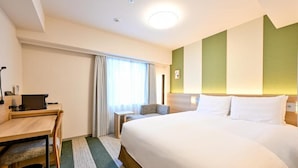 A hotel room with a bed, a desk, a chair, and a window with curtains. - Richmond Hotel Tenjin Nishi-dori (Fukuoka)