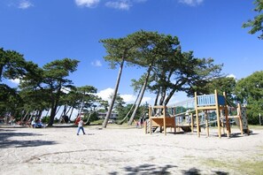 A playground with climbing structures and a sandy ground. - Ordinger Dün Holiday Apartment 6 (St. Peter-Ording)