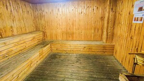 A sauna room with wooden walls and benches. - Cozy Suites at Saville Cheras by HCK (Cheras)