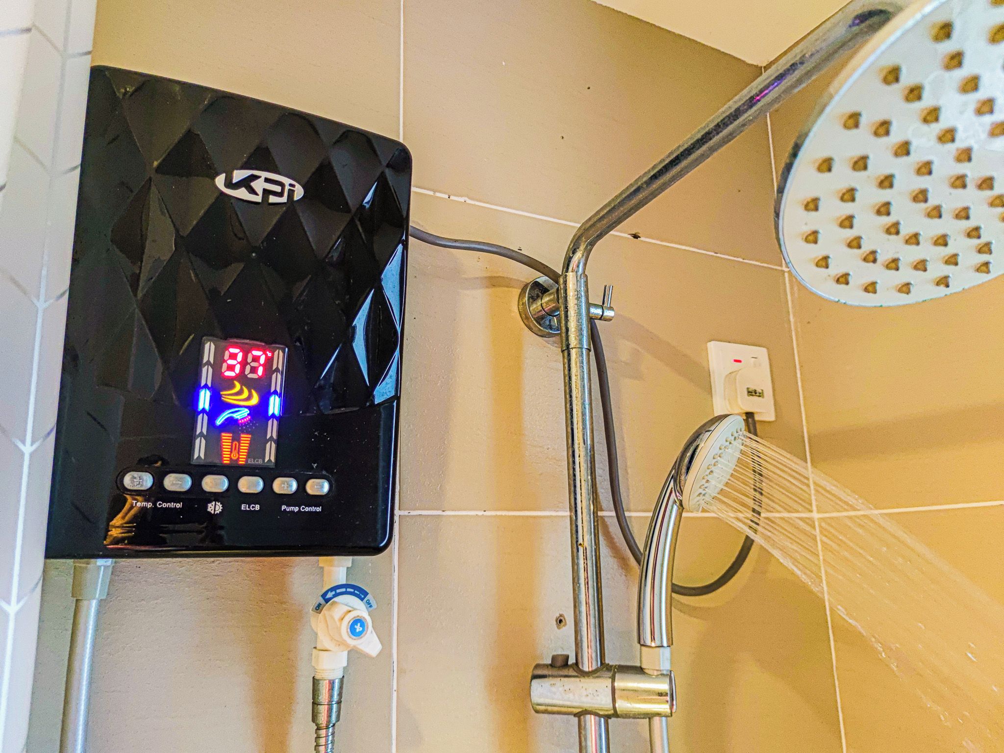 A digital control panel with a temperature display and a shower head.