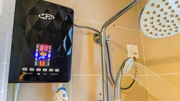 A digital control panel with a temperature display and a shower head.