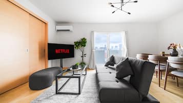 Apartment | Living area | 50-inch flat-screen TV with digital channels