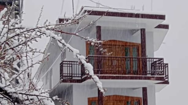 A multi-story building with balconies, surrounded by snow-covered trees. - The Veteran House (Haripur)