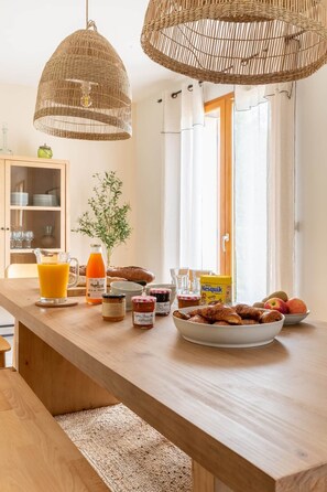 A breakfast table with bread, pastries, and condiments. - A modern, peaceful family retreat just 1 hour and 30 minutes from Paris (Le Mesnil-Lieubray)