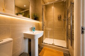 A modern bathroom with a glass shower enclosure, a pedestal sink, and a toilet. - Spacious Liverpool City Centre Apartment with View Managed by Sidemersey Livings (Liverpool)