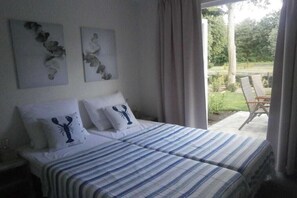 A bedroom with a bed, two pillows with a lobster design, and two wall art pieces. - Holiday home with 2 bedrooms (RB Hulshorst)
