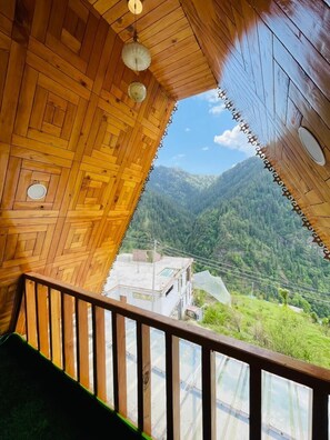 A wooden interior with a view of a mountainous landscape. - Latos Chapter Sajwar (Banjar)