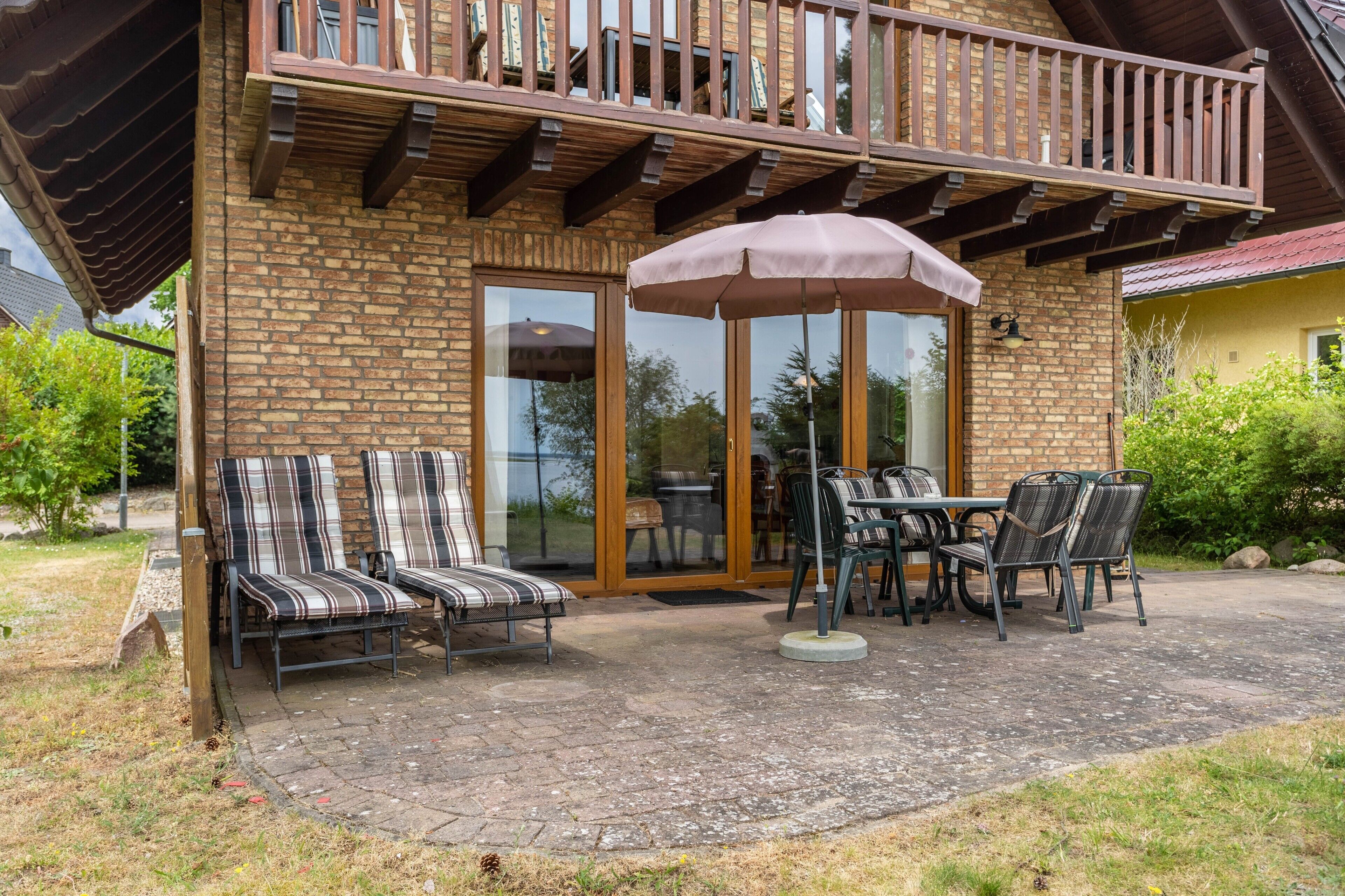 A patio with outdoor furniture, a table, and a large umbrella.