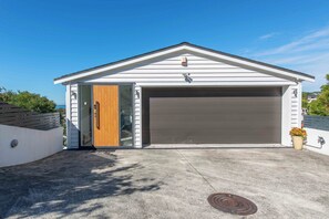 Eine moderne Garage mit Holztür und Rolltor.