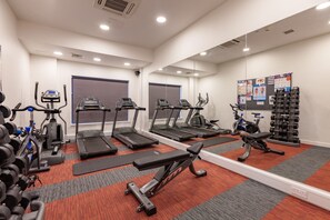 A gym with treadmills, elliptical machines, and weight benches. - Student Only Hannah Court (Sheffield)