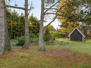A rustic outdoor setting with a swing, a small shed, and a gazebo. - "Alkmar" -  from the sea by Interhome (Hals)