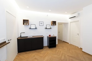 A modern interior with a reception desk, framed artwork, and a wooden floor. - Sweet Home 36-Vatican (Rome)