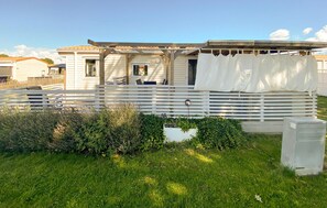 A mobile home with a porch, a white fence, and a small garden area. - 2 bedroom gorgeous home in Färjestaden (Färjestaden)