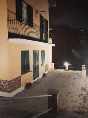 A two-story building with a balcony and a ground-level entrance. - 'Rifugio Del Benessere' Apartment (Monte Compatri)