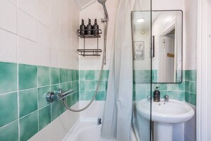 A bathroom with a shower, a sink, and a mirror. - The Geordie Getaway! (Newcastle upon Tyne)