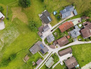 Eine Vogelperspektive eines Wohngebiets mit Häusern, Straßen und Grünflächen.