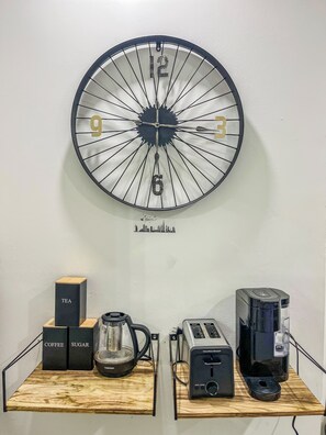 A wall clock with numbers and a city skyline silhouette below it. - 20 Mins to Metlife Stadium / Manhattan/ (Apt.2) (West New York)